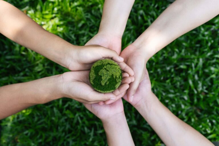 An image of a community taking care of the Earth by planting new sprouts.