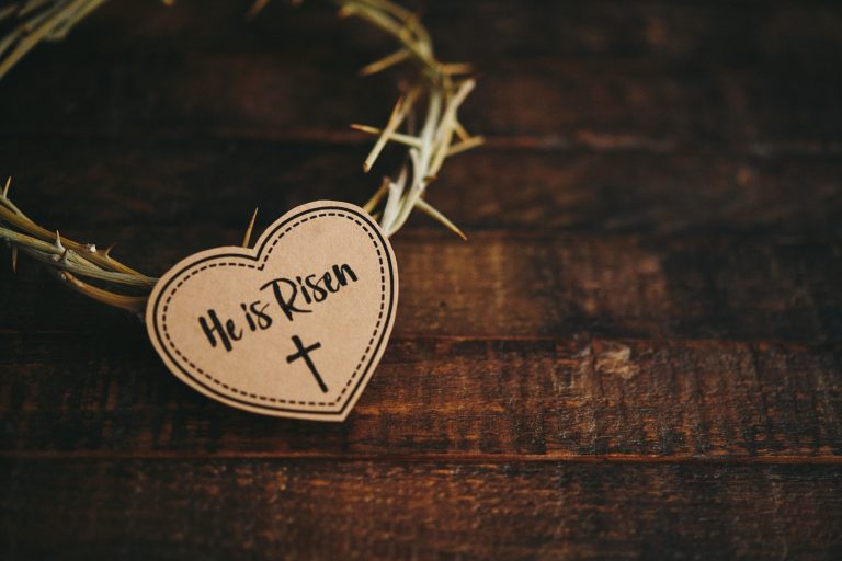 Easter religious background with He is Risen message on thorns.