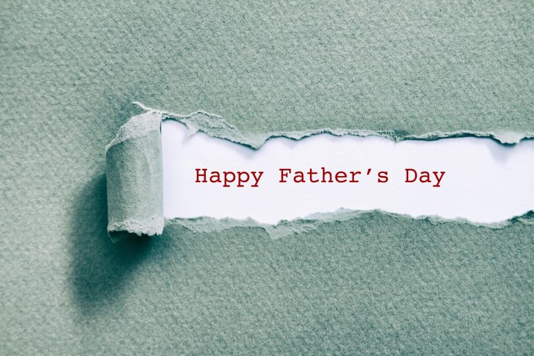 A cheerful "Happy Father's Day" message on a creatively torn paper background.