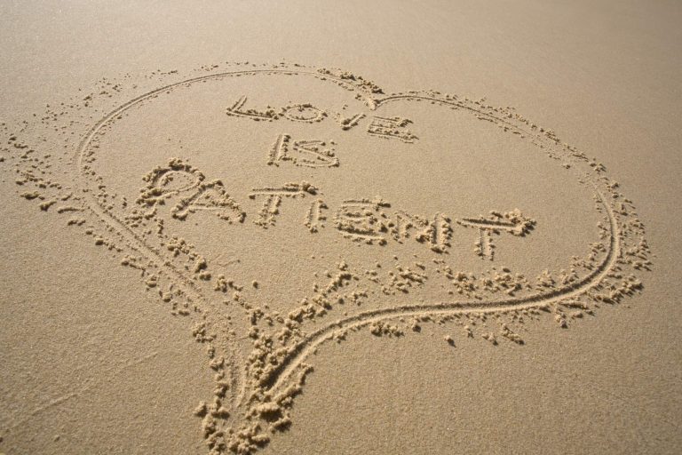 Sand art depicting a heart shape, with the word “Love” beautifully drawn in the center.