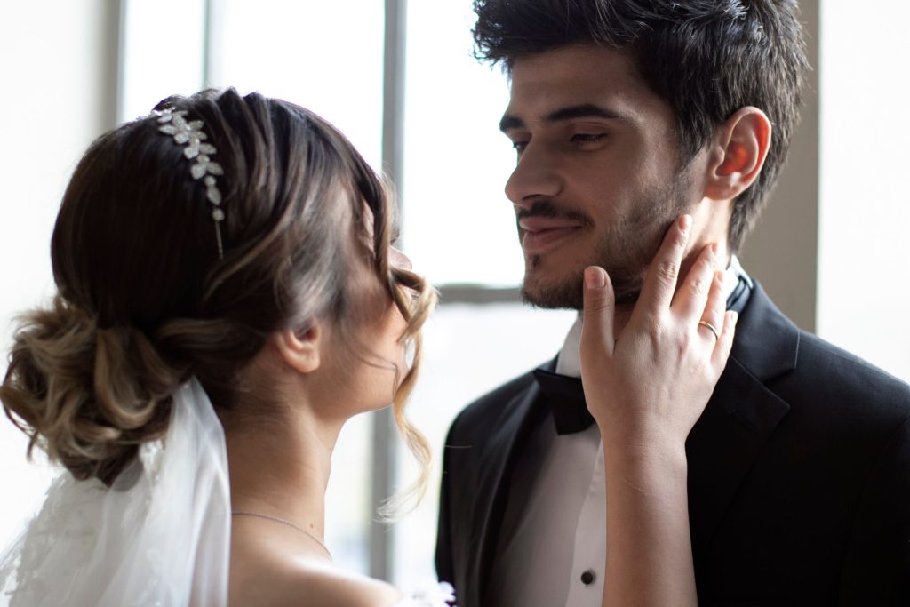 Newly wedded couple looking at each other, smiling. Embodying love in marriage. concept.