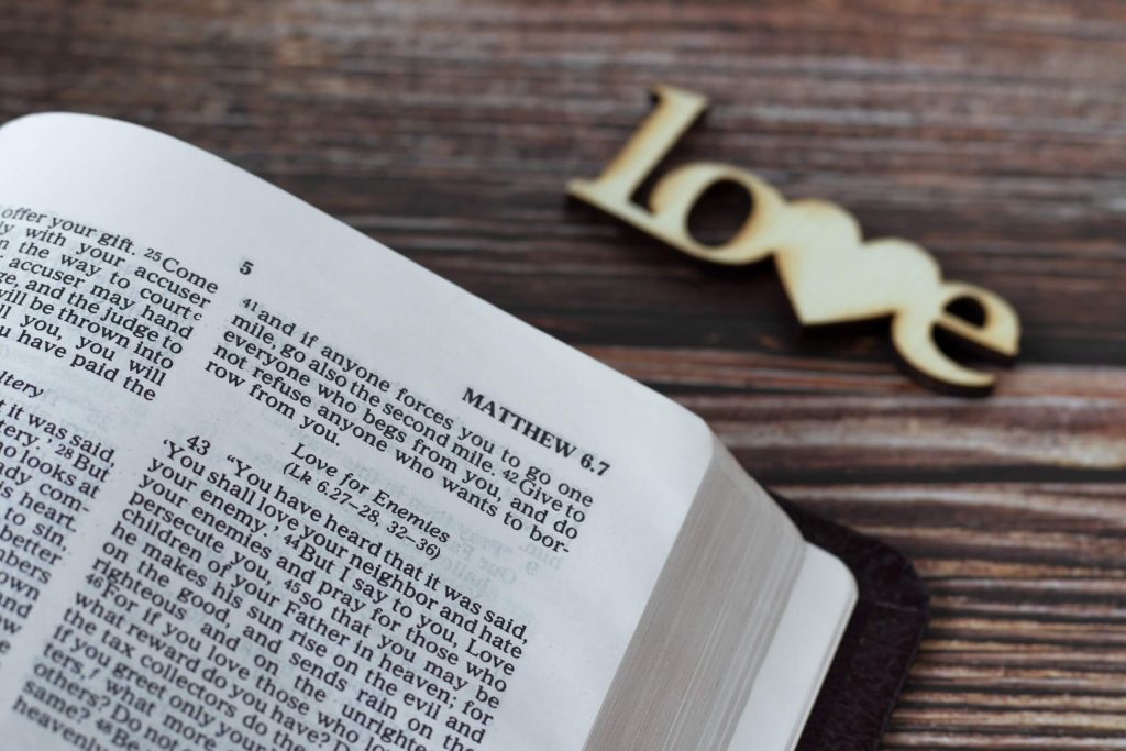 A close-up of Bible page featuring teaching on loving enemies, showcasing the concept of love in challenging relationships.