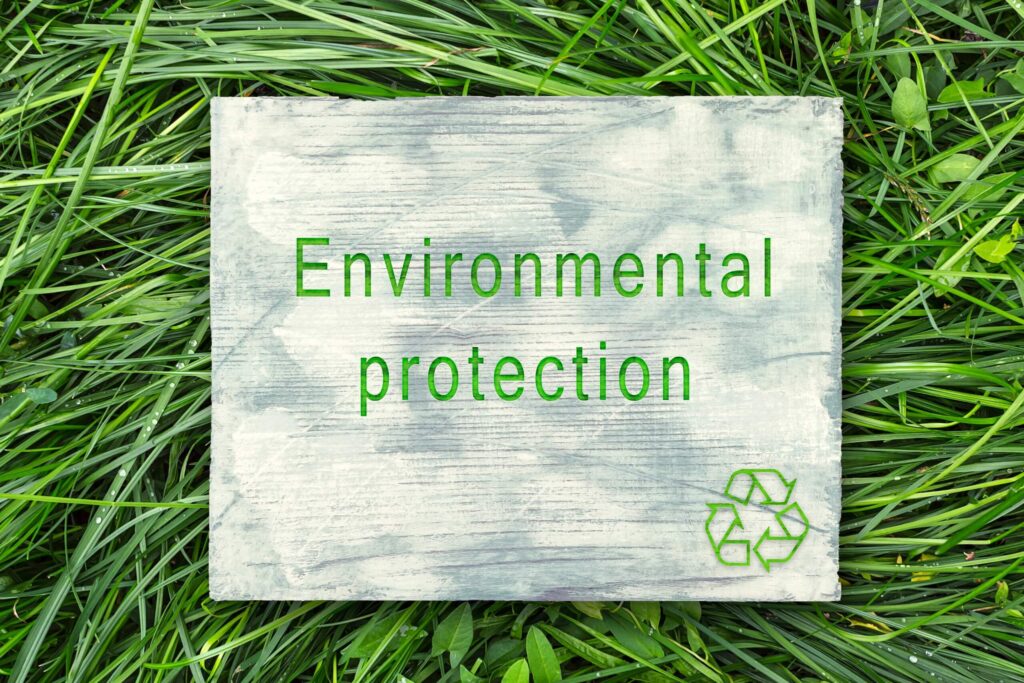 Expansive green grass with a recycling sign, representing a commitment to environmental protection and recycling initiatives.